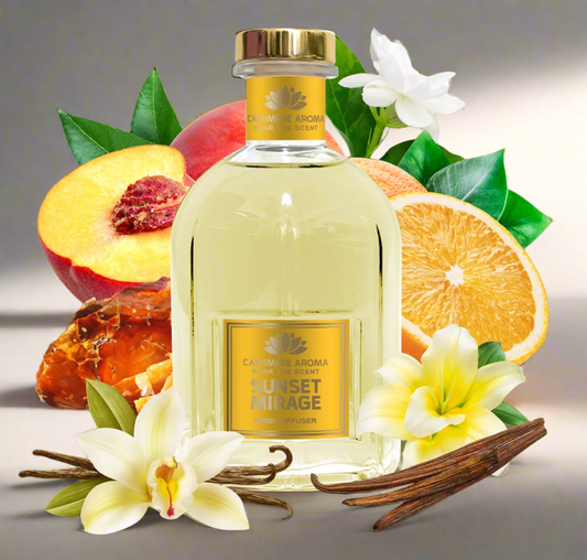Bottle of 'Sunset Mirage' perfume surrounded by fruits, flowers, and vanilla beans on a green background