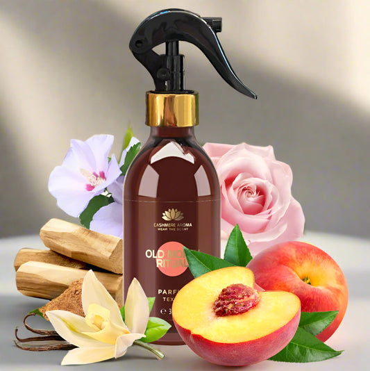 Brown spray bottle with floral and fruit elements on a light background